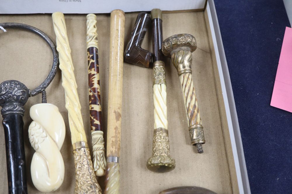 A group of silver, gilt metal and ivory walking cane and parasol handles.